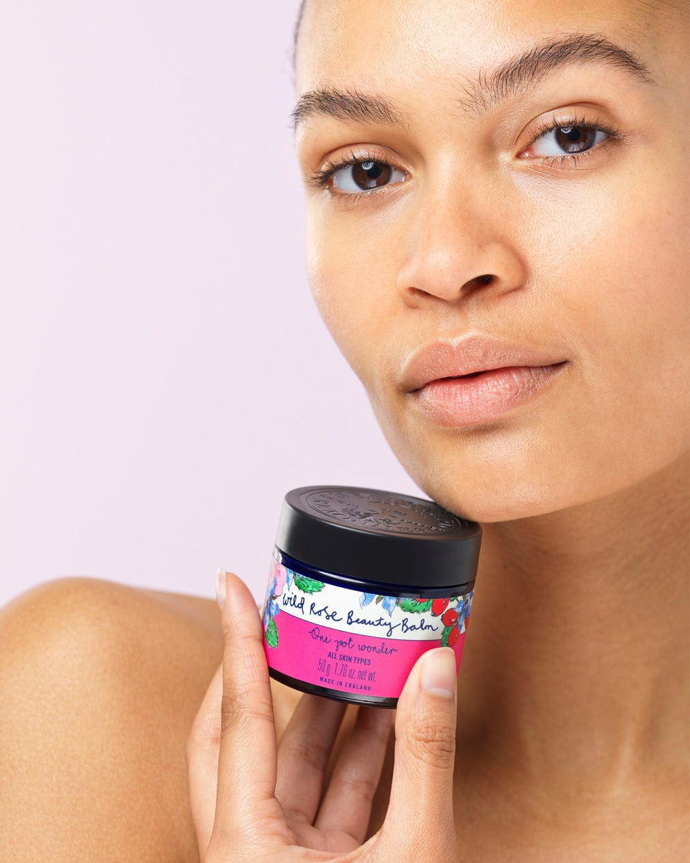Model holding Wild Rose Beauty Balm